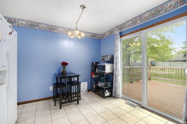 1612 W Grant St, Bremen, IN 46506 - dining space featuring a chandelier, light tile patterned floors, and baseboards