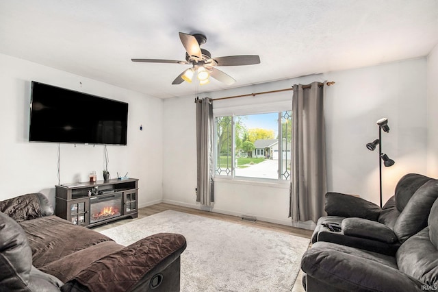 1612 W Grant St, Bremen, IN 46506 - living area featuring ceiling fan, wood finished floors, and baseboards