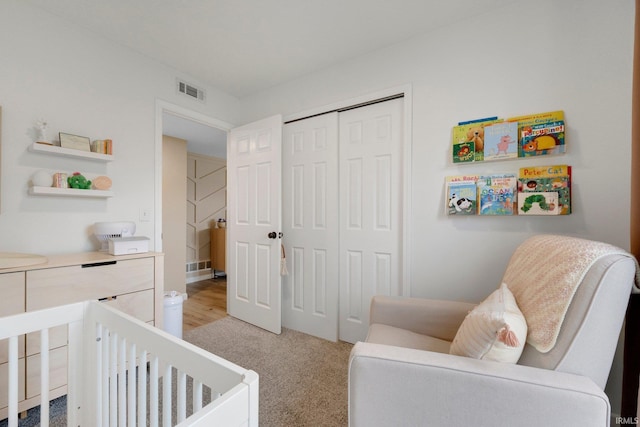 bedroom featuring light colored carpet and a closet