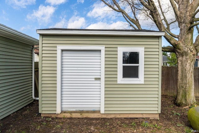 view of shed featuring fence