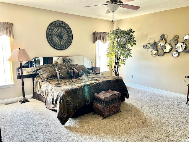 carpeted bedroom with baseboards and ceiling fan