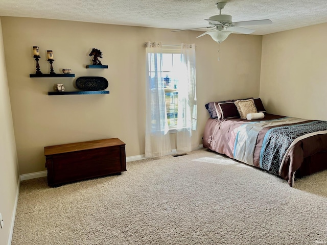 bedroom with a textured ceiling, carpet flooring, baseboards, and a ceiling fan