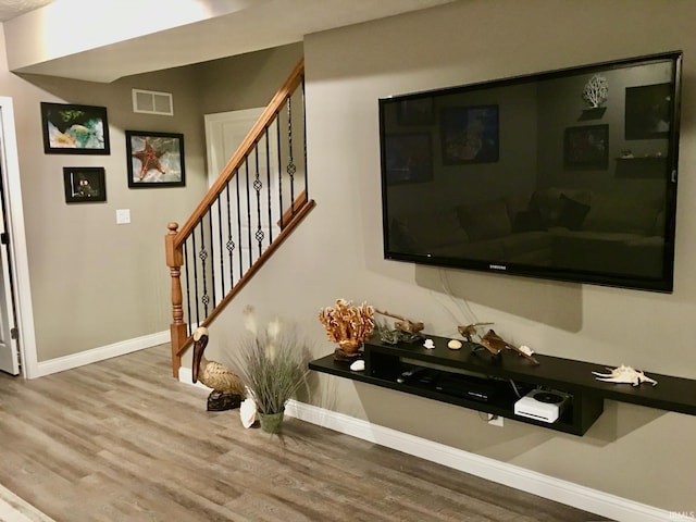 stairway featuring wood finished floors and baseboards