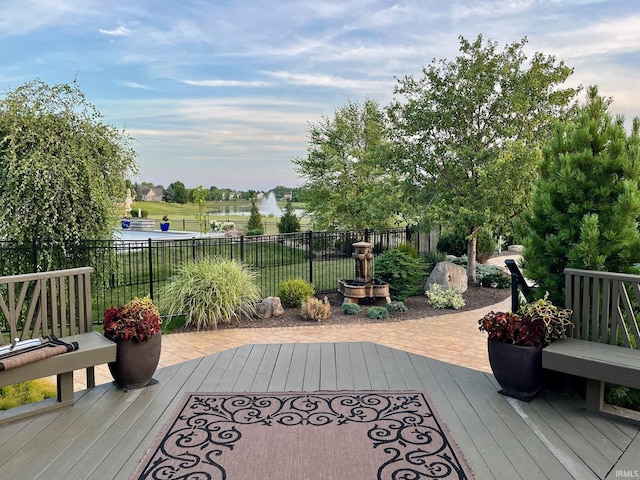 wooden deck featuring fence and a water view