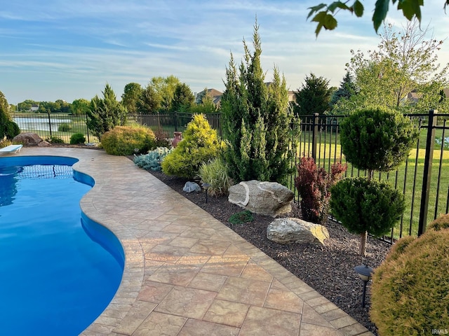 view of swimming pool featuring a fenced backyard and a patio area