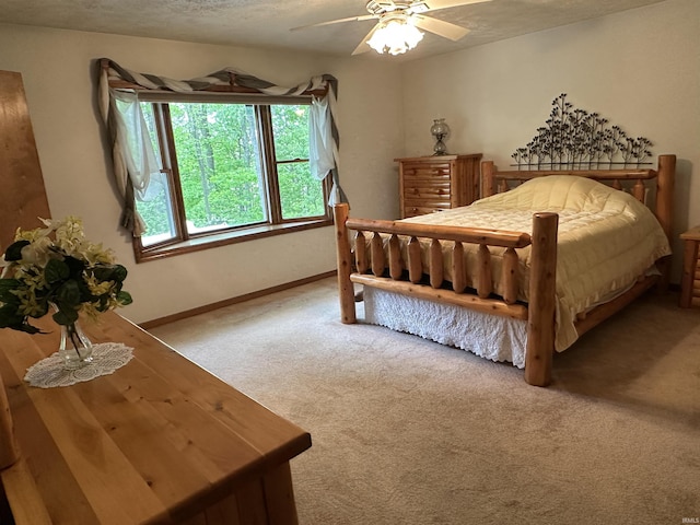 carpeted bedroom featuring baseboards and ceiling fan