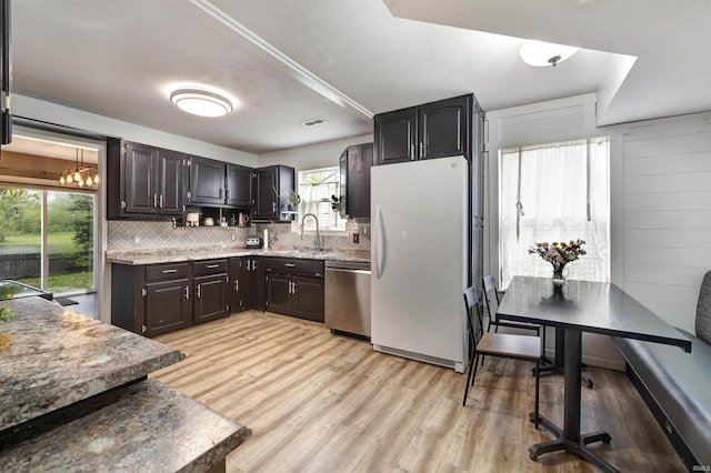 116 El Dorado Trl W, Fort Wayne, IN 46825 - kitchen with freestanding refrigerator, stainless steel dishwasher, a sink, tasteful backsplash, and light wood-style floors