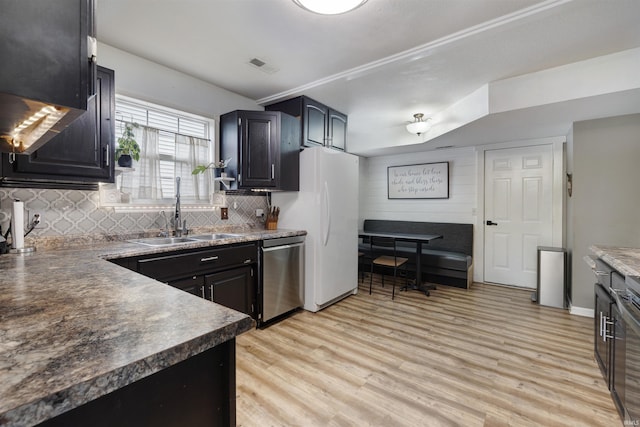 116 El Dorado Trl W, Fort Wayne, IN 46825 - kitchen featuring dishwasher, a sink, decorative backsplash, light wood-style floors, and freestanding refrigerator