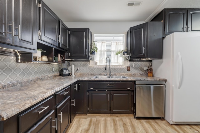 116 El Dorado Trl W, Fort Wayne, IN 46825 - kitchen featuring a sink, dishwasher, freestanding refrigerator, light wood-style floors, and decorative backsplash