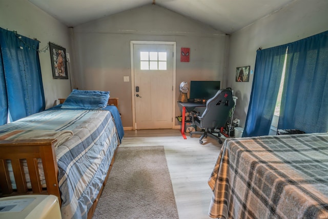 bedroom featuring wood finished floors and vaulted ceiling