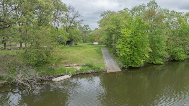 aerial view of property and surrounding area featuring a nearby body of water