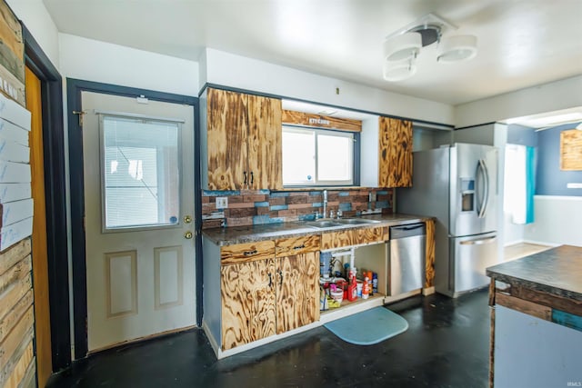 kitchen featuring stainless steel appliances, a sink, dark countertops, decorative backsplash, and brown cabinets