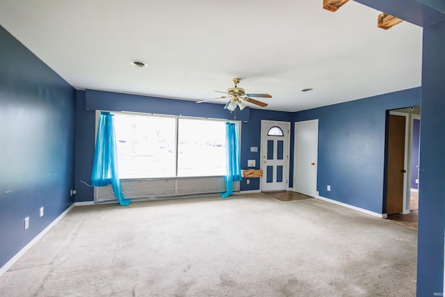 unfurnished room featuring ceiling fan, carpet, and baseboards
