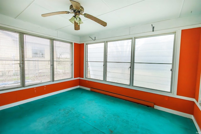 unfurnished sunroom featuring baseboard heating and healthy amount of natural light
