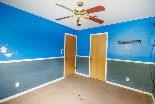 unfurnished bedroom with ceiling fan and baseboards