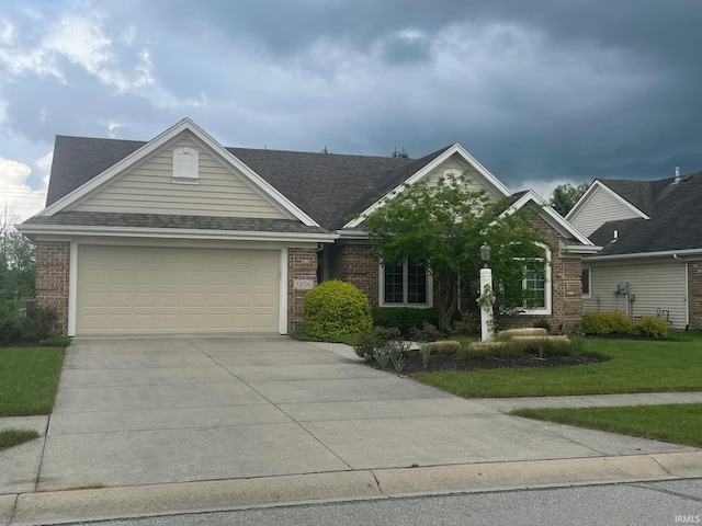 12116 Autumn Breeze Dr, Fort Wayne, IN 46845 - view of front of home featuring brick siding, driveway, a garage, roof with shingles, and a front yard