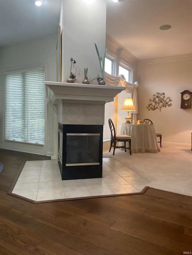 12116 Autumn Breeze Dr, Fort Wayne, IN 46845 - detailed view of a tiled fireplace, crown molding, wood finished floors, baseboards, and recessed lighting