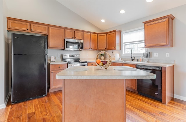 11430 Kestrel Ct, Evansville, IN 47725 - kitchen featuring black appliances, light countertops, light wood-style floors, vaulted ceiling, and a sink