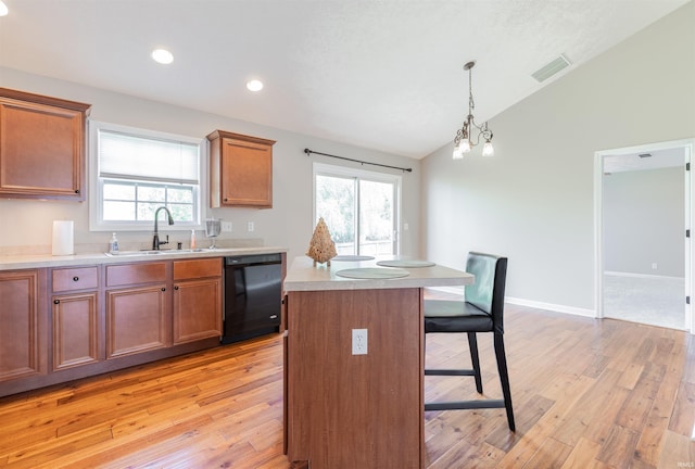 11430 Kestrel Ct, Evansville, IN 47725 - kitchen featuring a sink, dishwasher, a breakfast bar area, light wood-style floors, and lofted ceiling