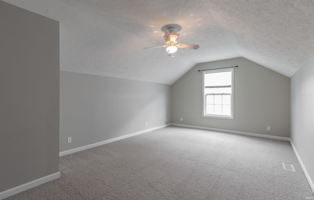 11430 Kestrel Ct, Evansville, IN 47725 - additional living space featuring carpet floors, a textured ceiling, baseboards, vaulted ceiling, and ceiling fan