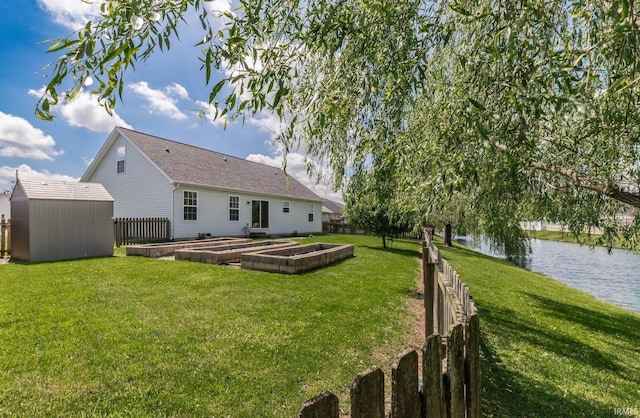 11430 Kestrel Ct, Evansville, IN 47725 - back of house featuring a water view, a garden, a storage shed, and an outbuilding