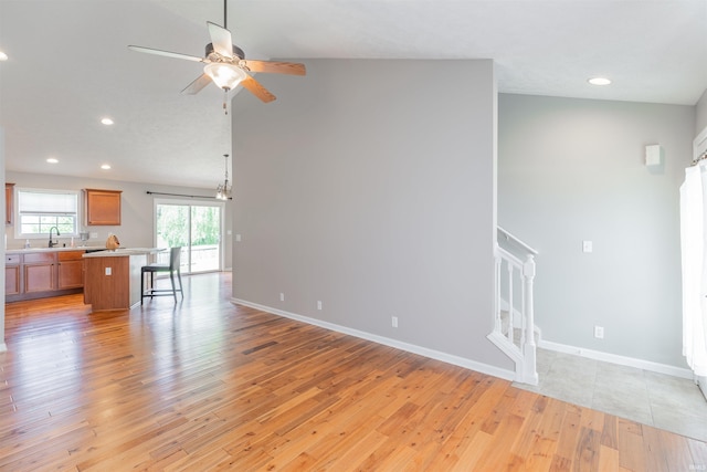 11430 Kestrel Ct, Evansville, IN 47725 - unfurnished living room with a ceiling fan, light wood-type flooring, recessed lighting, a sink, and baseboards