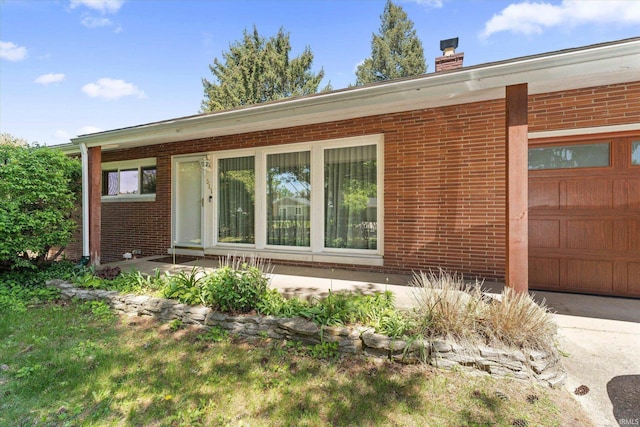 511 Peashway St, South Bend, IN 46617 - view of front of home featuring brick siding, a chimney, and a garage