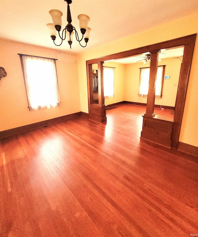 625 S 29th St, Lafayette, IN 47904 - spare room featuring a chandelier, wood finished floors, baseboards, and a ceiling fan