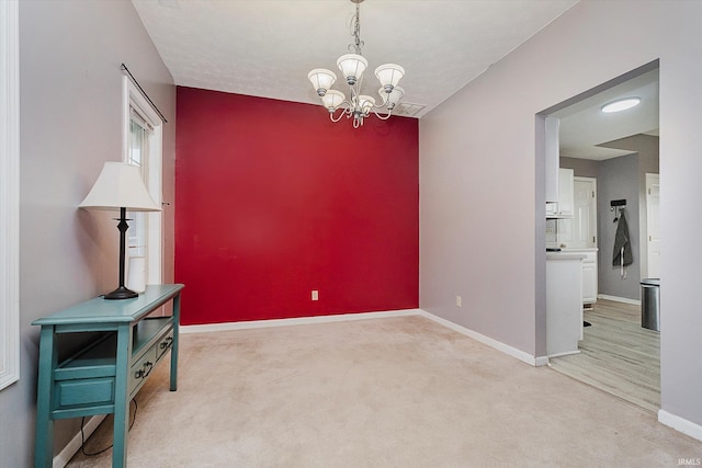 2507 Audri Ln, Kokomo, IN 46901 - unfurnished room featuring baseboards, a chandelier, and light colored carpet
