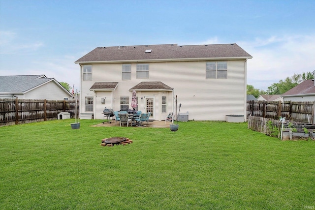 2507 Audri Ln, Kokomo, IN 46901 - rear view of house featuring a patio, a garden, and a fire pit