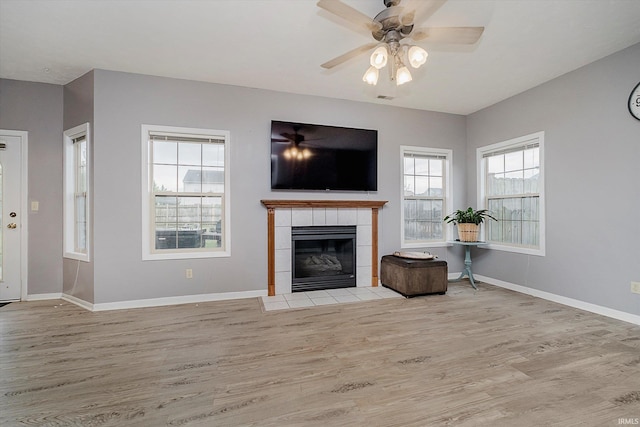 2507 Audri Ln, Kokomo, IN 46901 - living area with wood finished floors, a fireplace, a ceiling fan, and baseboards