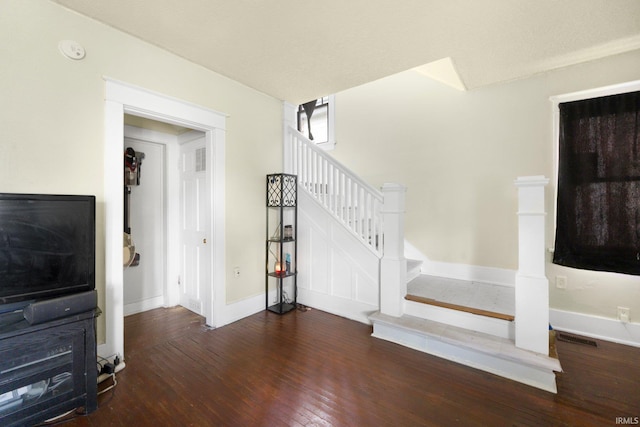 stairway with wood-type flooring and baseboards