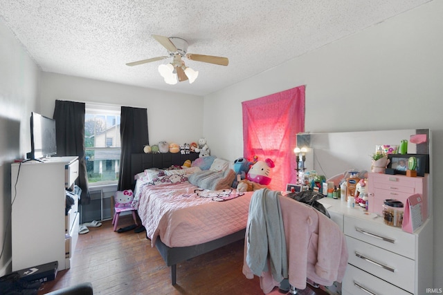 bedroom with hardwood / wood-style flooring, a textured ceiling, and ceiling fan