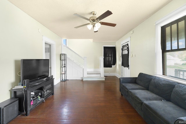 living room featuring wood finished floors, stairway, ceiling fan, and baseboards