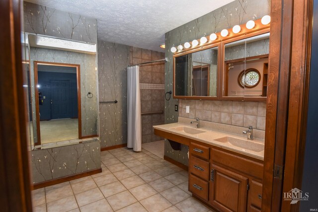 4105 W Friar Dr, Muncie, IN 47304 - full bathroom with a textured ceiling, tile patterned flooring, curtained shower, backsplash, and double vanity