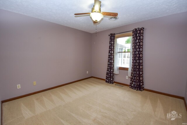 4105 W Friar Dr, Muncie, IN 47304 - empty room with carpet flooring, a ceiling fan, baseboards, and a textured ceiling