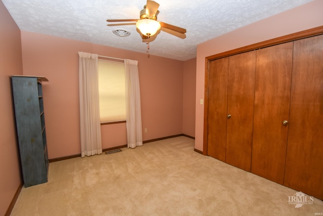 4105 W Friar Dr, Muncie, IN 47304 - unfurnished bedroom featuring light carpet, a textured ceiling, a closet, baseboards, and ceiling fan