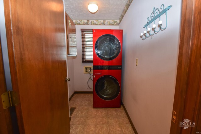 4105 W Friar Dr, Muncie, IN 47304 - laundry area featuring stacked washer / dryer, baseboards, tile patterned flooring, and a textured ceiling