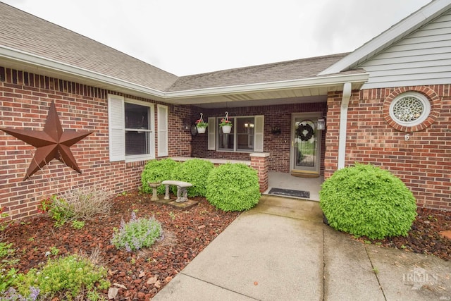 4105 W Friar Dr, Muncie, IN 47304 - property entrance with brick siding, a shingled roof, and covered porch