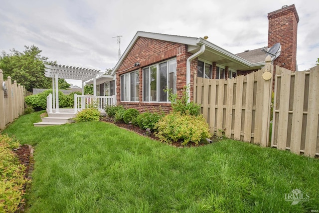 4105 W Friar Dr, Muncie, IN 47304 - view of side of home with brick siding, a pergola, and a deck