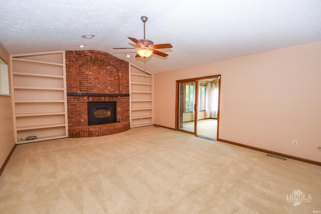 4105 W Friar Dr, Muncie, IN 47304 - unfurnished living room featuring lofted ceiling, ceiling fan, baseboards, a brick fireplace, and built in shelves