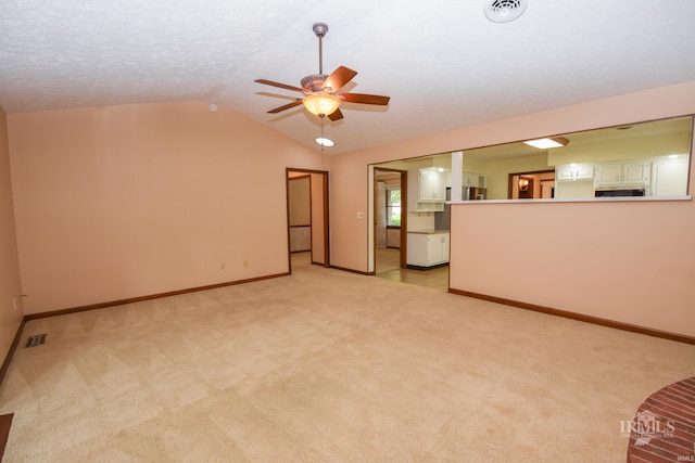 4105 W Friar Dr, Muncie, IN 47304 - unfurnished living room featuring ceiling fan, lofted ceiling, light carpet, and baseboards