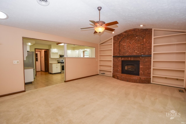 4105 W Friar Dr, Muncie, IN 47304 - unfurnished living room featuring lofted ceiling, baseboards, built in shelves, ceiling fan, and light colored carpet