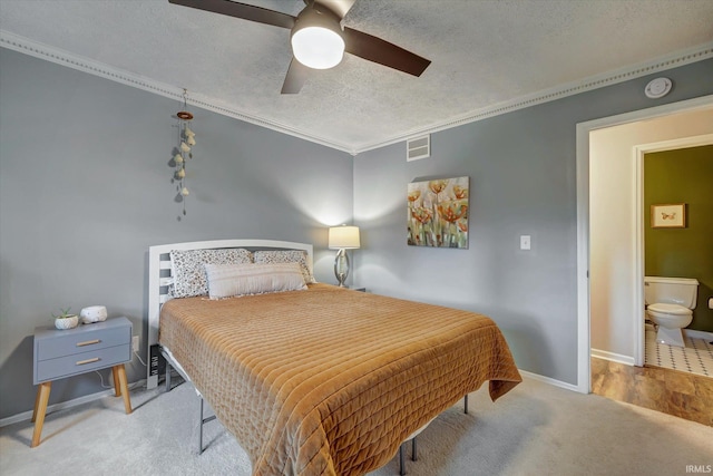 bedroom with a textured ceiling, carpet flooring, baseboards, ceiling fan, and crown molding