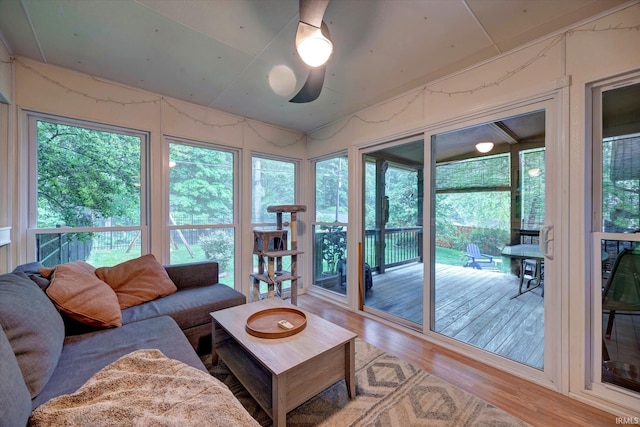 living room with wood finished floors, plenty of natural light, and a ceiling fan