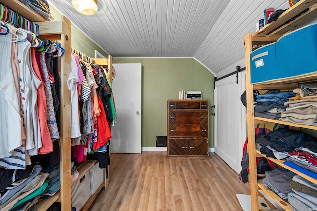 1134 N 14th St, Lafayette, IN 47904 - walk in closet with a barn door, wood finished floors, and vaulted ceiling