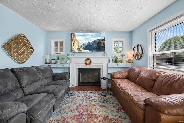1134 N 14th St, Lafayette, IN 47904 - living area with a textured ceiling, a fireplace, and wood finished floors