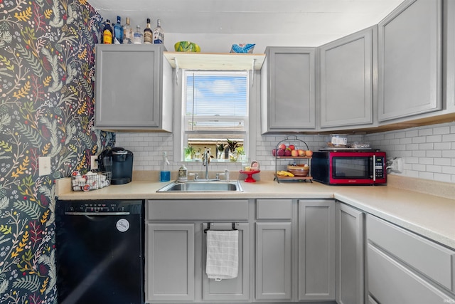 1134 N 14th St, Lafayette, IN 47904 - kitchen with dishwasher, a sink, wallpapered walls, light countertops, and decorative backsplash