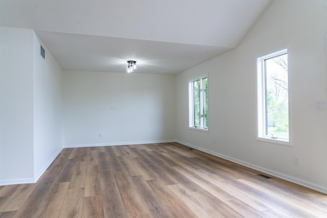 2375 N 110 W, Angola, IN 46703 - spare room with wood finished floors, baseboards, and vaulted ceiling