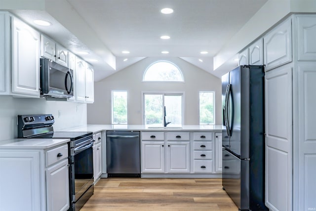2375 N 110 W, Angola, IN 46703 - kitchen with appliances with stainless steel finishes, a peninsula, a sink, lofted ceiling, and light countertops